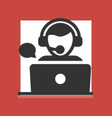 An icon of a support agent on call while using a laptop